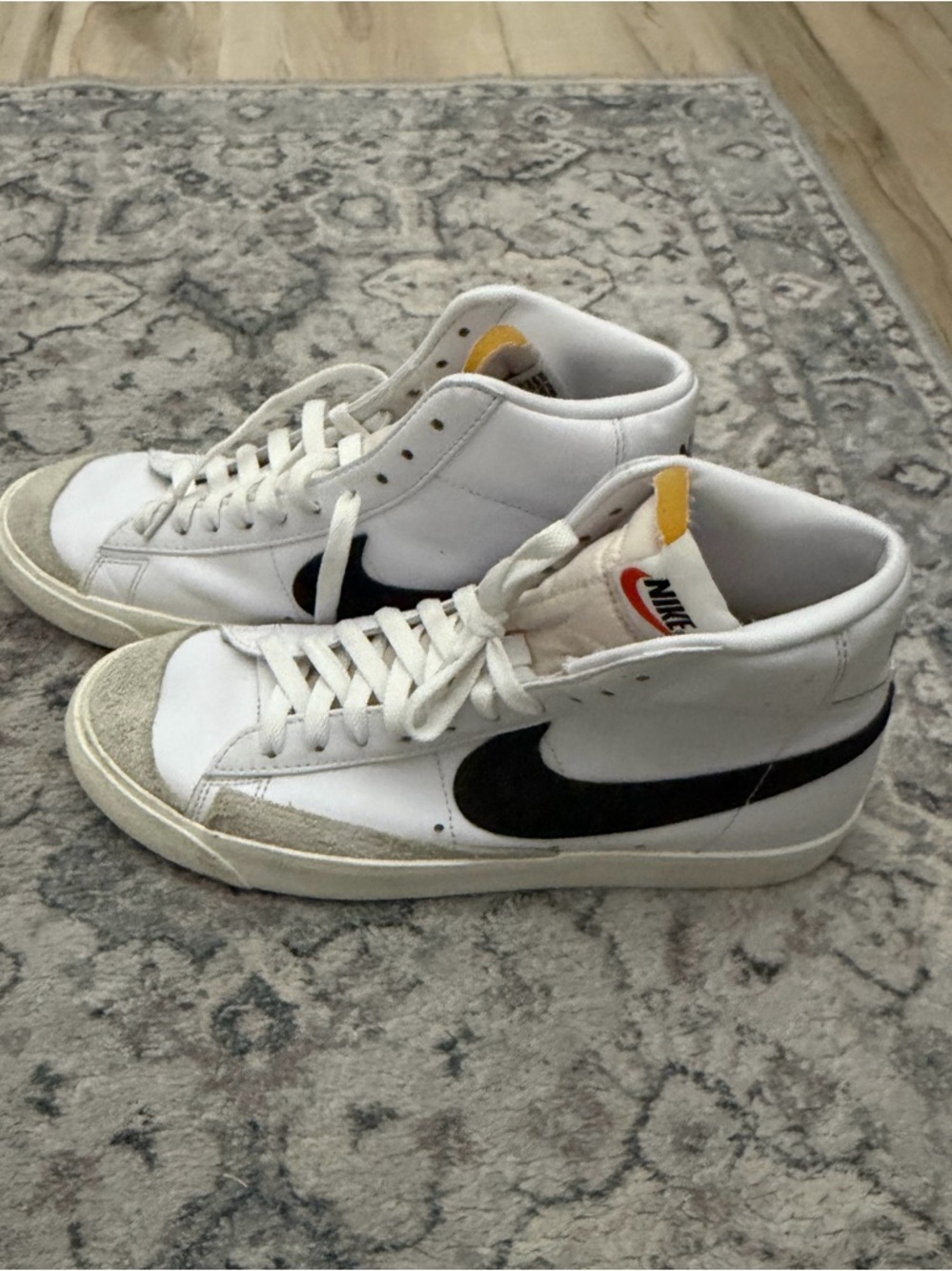Nike White High-Top Sneakers with Black Swoosh and Yellow Tongue Tab